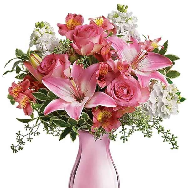 Pink roses and lilies in a pink glass vase