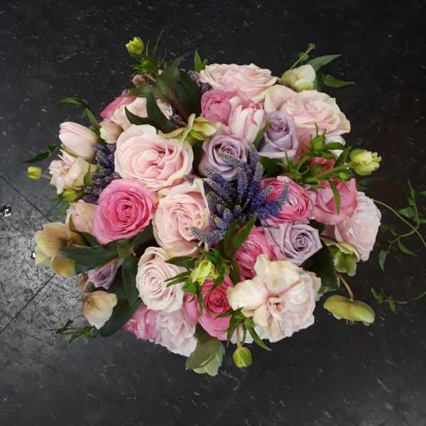 Bouquet of pink and lavender roses with purple accents