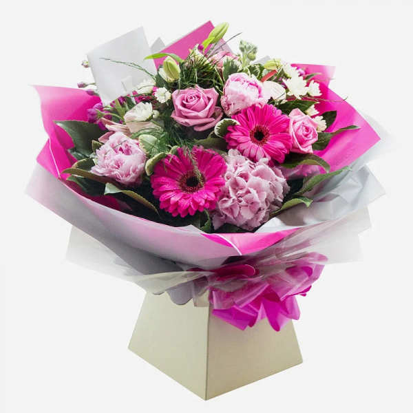 Pink and white mixed bouquet wrapped in bright paper