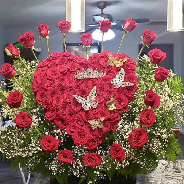 Heart-shaped red rose arrangement with butterfly decorations