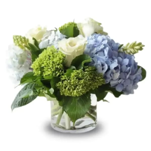 Blue and white hydrangea bouquet in a clear glass vase