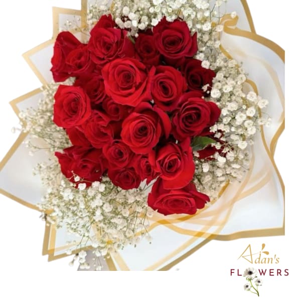 Bouquet of red roses with white baby's breath wrapped in white and gold paper