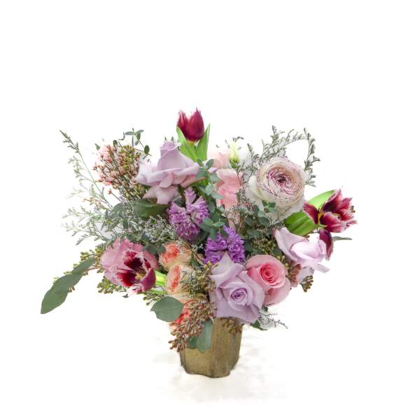 Bouquet of pink and lavender flowers in a gold vase