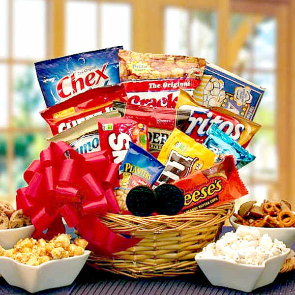 Basket of assorted snack bags with popcorn bowls and a red bow