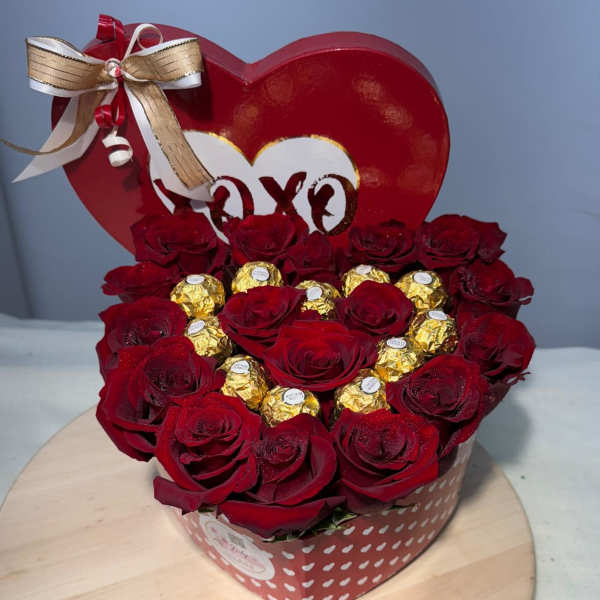 Heart-shaped box of red roses with gold-wrapped chocolates and a ribbon bow