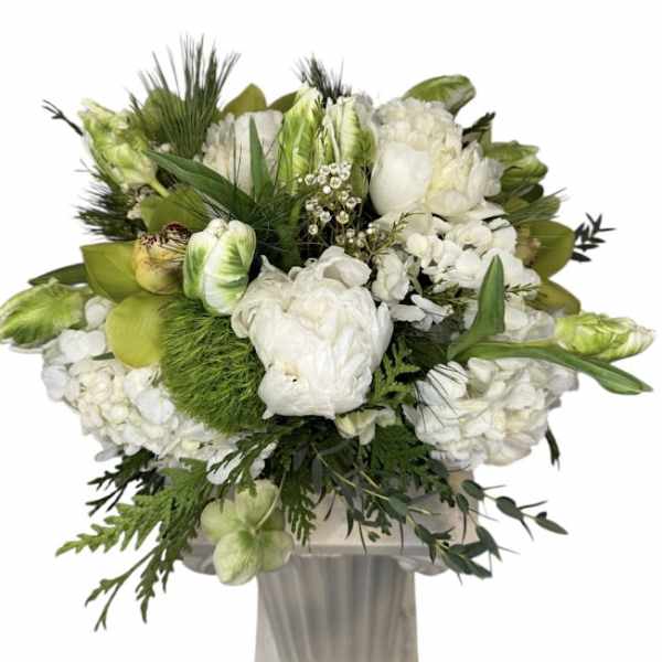 White and green floral arrangement in a tall vase