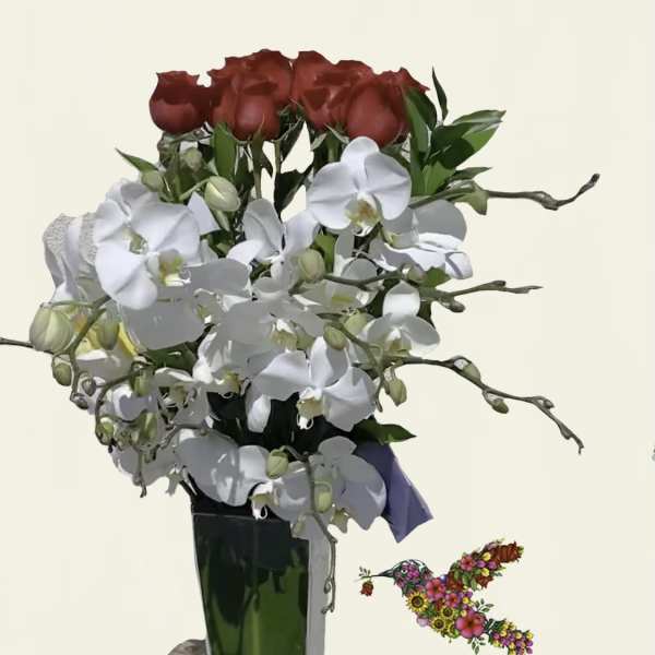 Red roses and white orchids in a tall glass vase