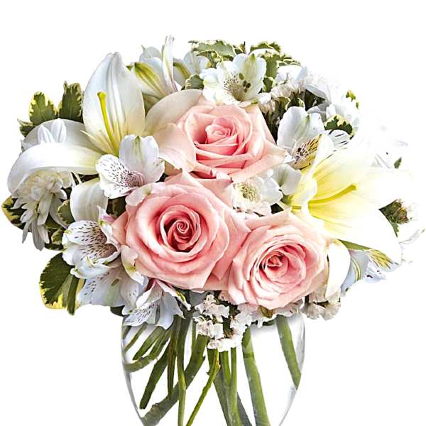 Pink roses and white lilies in a clear glass vase