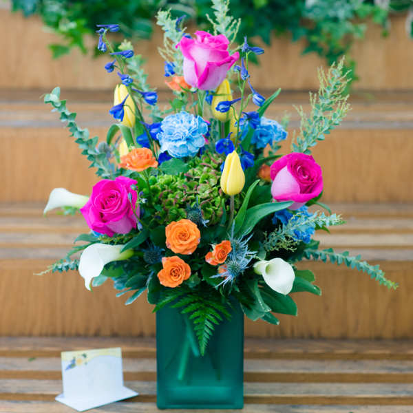 Colorful mixed bouquet in a green rectangular vase