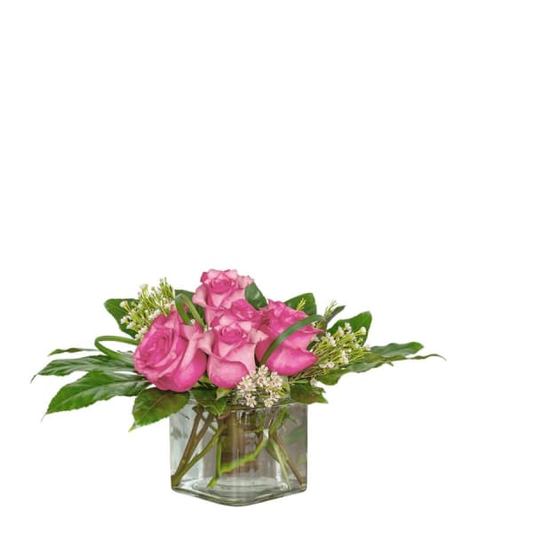 Pink roses arranged in a clear glass vase