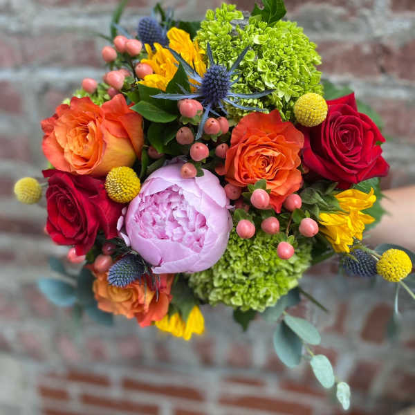 Colorful bouquet of roses, peonies, and green hydrangeas