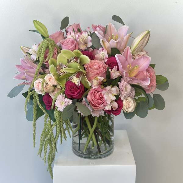 Pink and green mixed bouquet in a clear glass vase