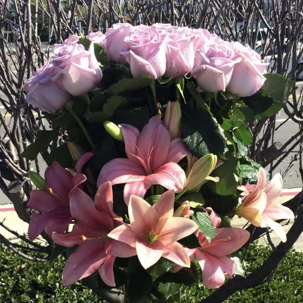 Pink roses and lilies arranged in a bouquet