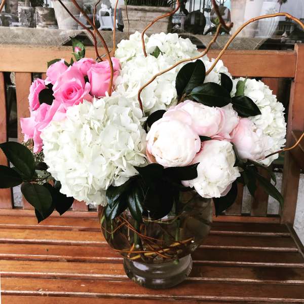Pink roses and white hydrangeas in a glass vase