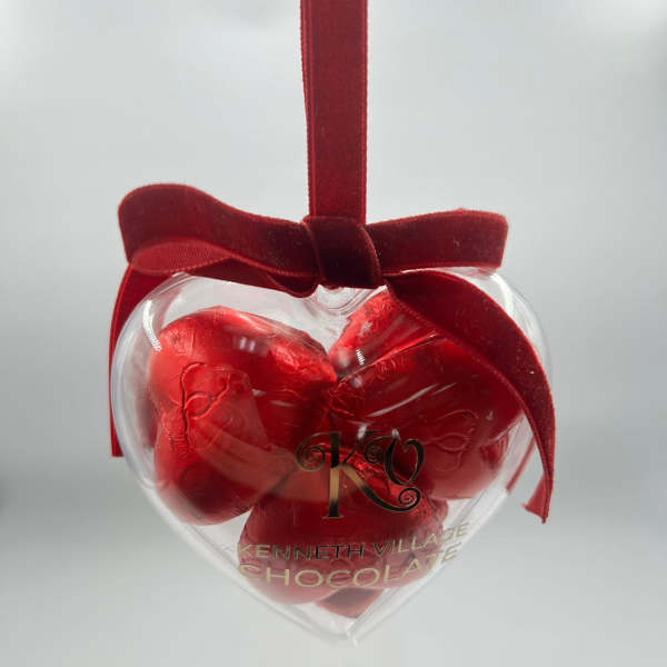 Heart-shaped chocolate gift box with a red ribbon bow