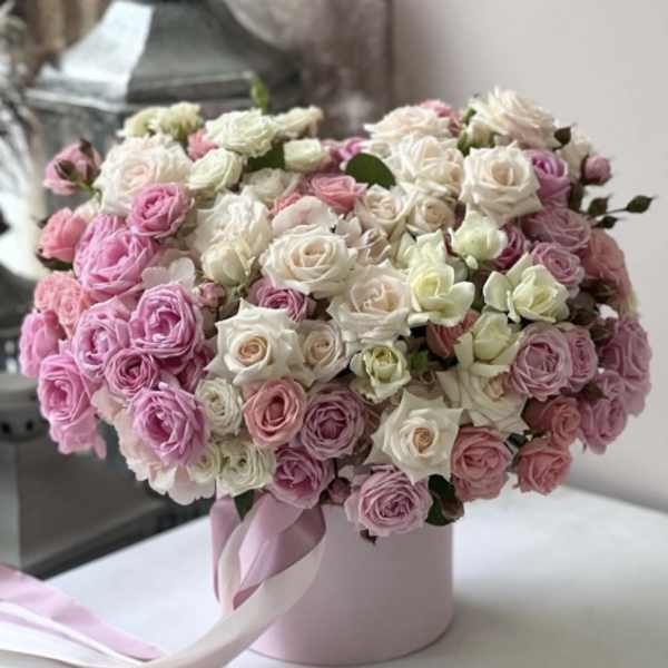 Pink and white rose bouquet in a round pink box with ribbon
