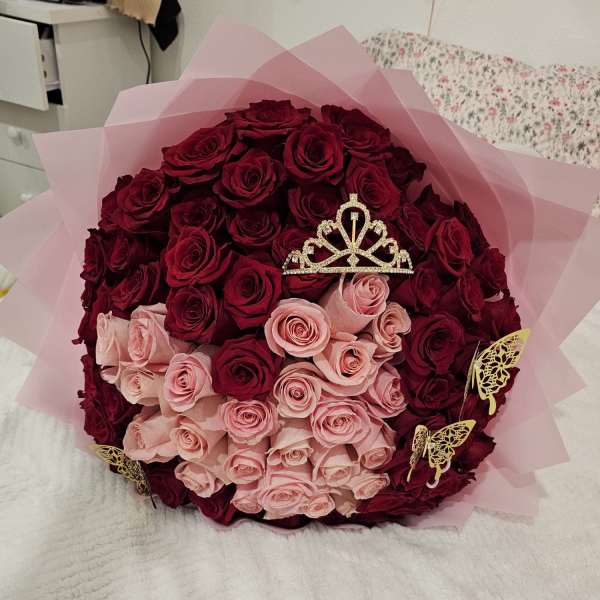Bouquet of dark red and pale pink roses with a tiara topper