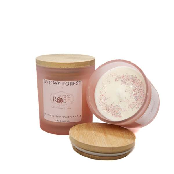 Pink rose-scented candle in a glass jar with a wooden lid