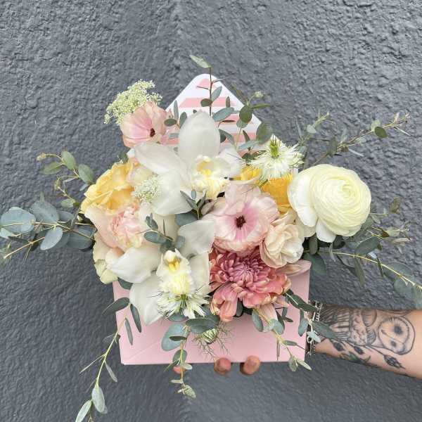 Pastel bouquet in a pink box with white orchids and roses