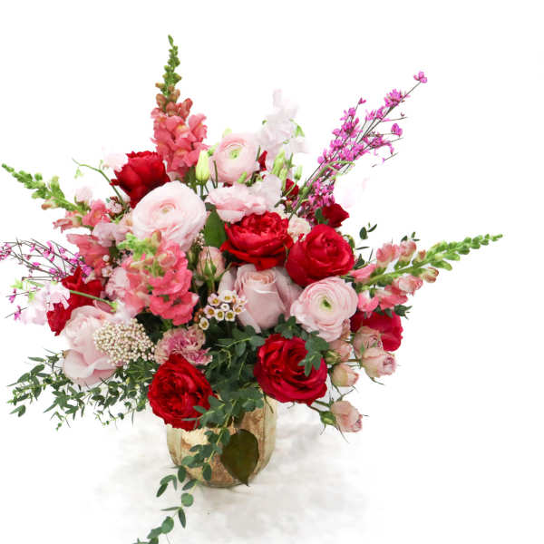 Pink and red mixed flower arrangement in a vase
