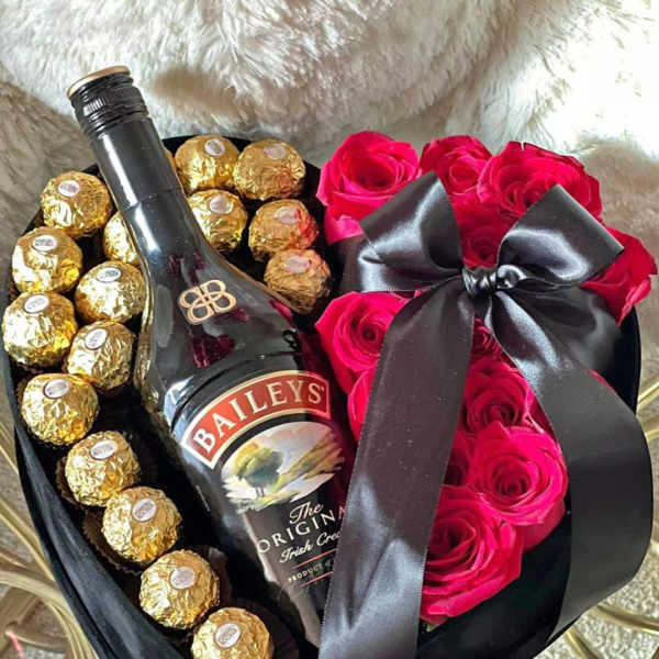 Heart-shaped gift box with pink roses, Ferrero Rocher chocolates, and a Baileys bottle