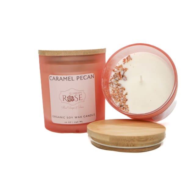 Two caramel pecan candles with wooden lids on a white background
