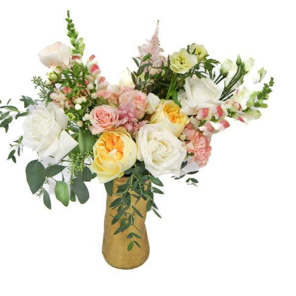 Mixed bouquet of white, pink, and yellow flowers in a gold vase