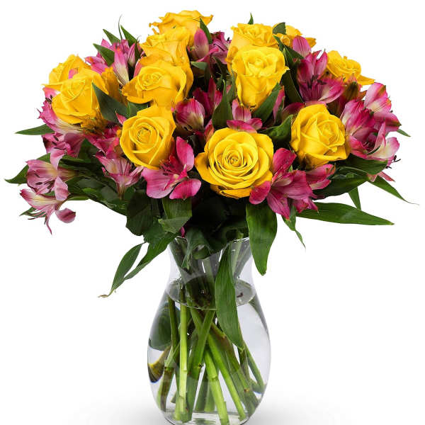 Yellow rose and pink alstroemeria bouquet arranged in a clear glass vase