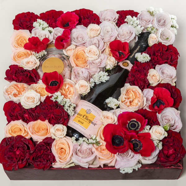 Square floral gift box with roses, poppies, and champagne bottles