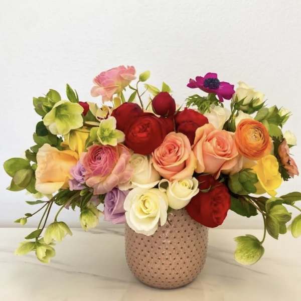 Colorful rose arrangement in a dotted ceramic vase