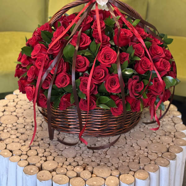 Basket of red roses with ribbon streamers