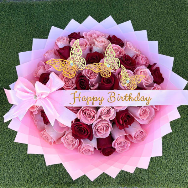 Pink and red rose bouquet with butterfly decorations and a Happy Birthday ribbon