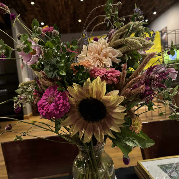 Mixed bouquet with a sunflower in a glass vase