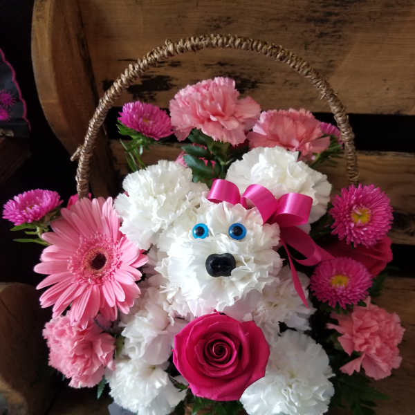 Pink and white flower basket shaped like a teddy bear with a ribbon bow