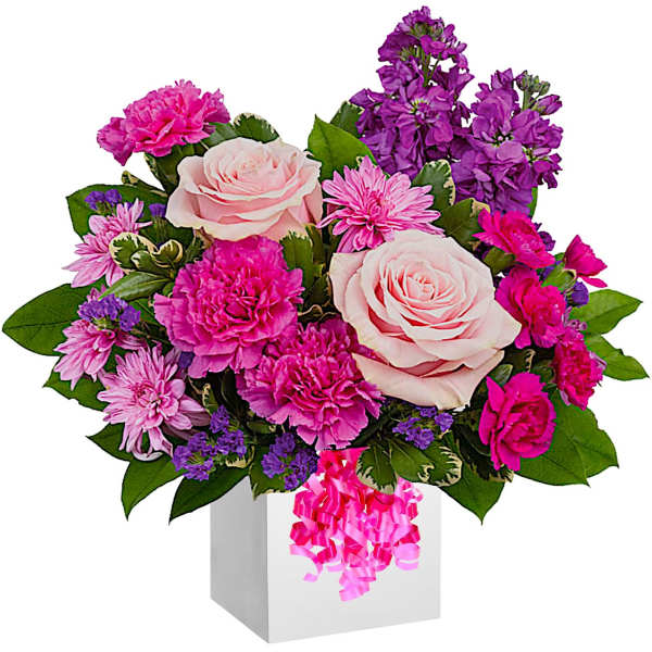 Pink and purple flower arrangement in a white box with ribbon