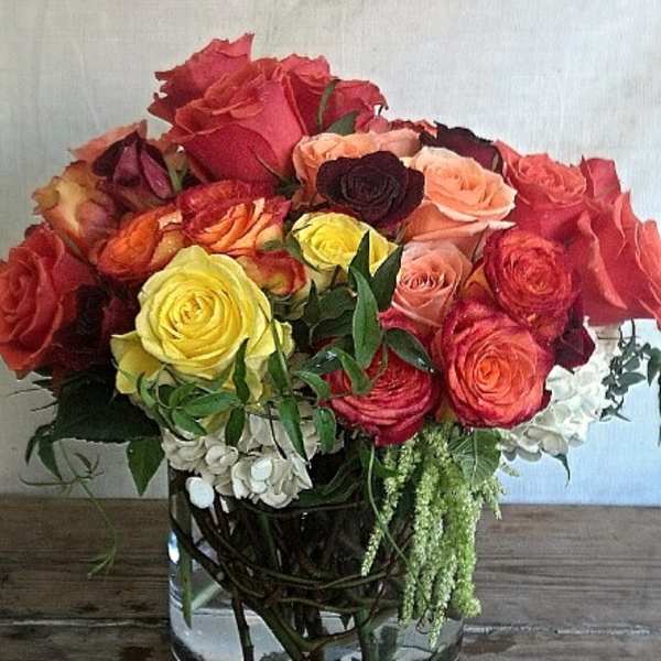 Mixed roses in a clear glass vase