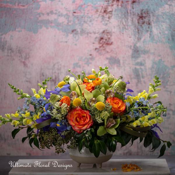 Colorful mixed flower arrangement in a low ceramic bowl