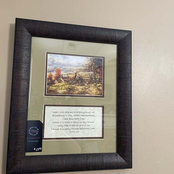 Framed wall art with a hunting scene and a Bible verse