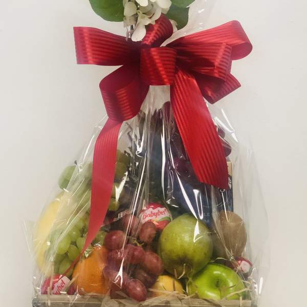 Fruit basket with a white floral topper and red ribbon