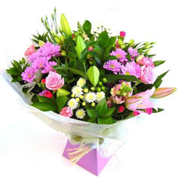 Bouquet of pink and purple flowers wrapped in white paper
