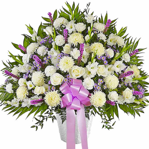 White floral spray with a pink ribbon in a vase