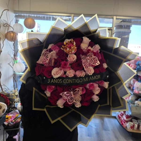 Large bouquet of pink and burgundy roses with butterfly decorations