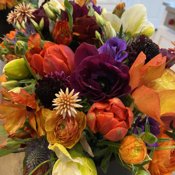 Bright mixed bouquet with orange, purple, yellow, and white blooms