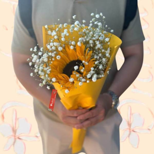 Sunflower bouquet wrapped in yellow paper with baby's breath