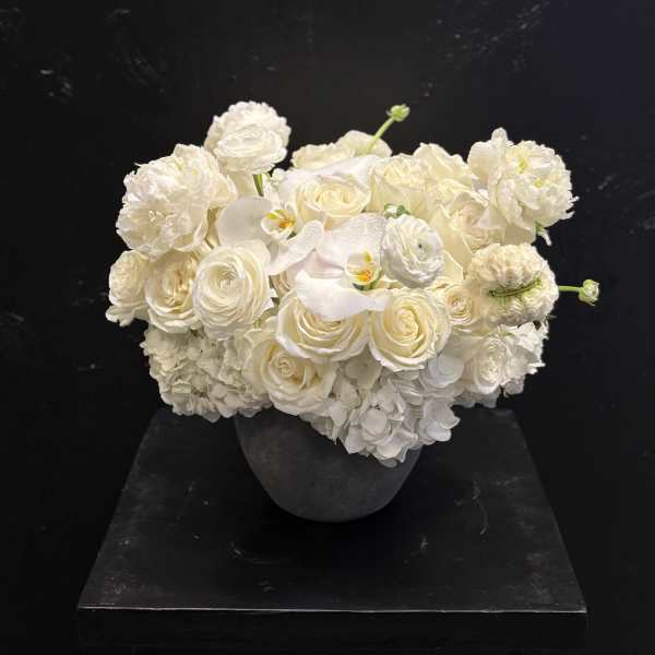 White rose and hydrangea arrangement in a dark vase