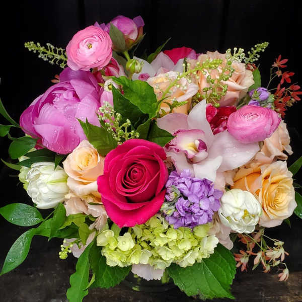 Mixed bouquet of pink, peach, white, and purple flowers