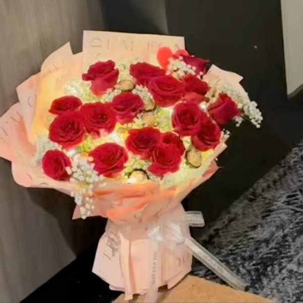 Bouquet of red roses wrapped in pale pink paper