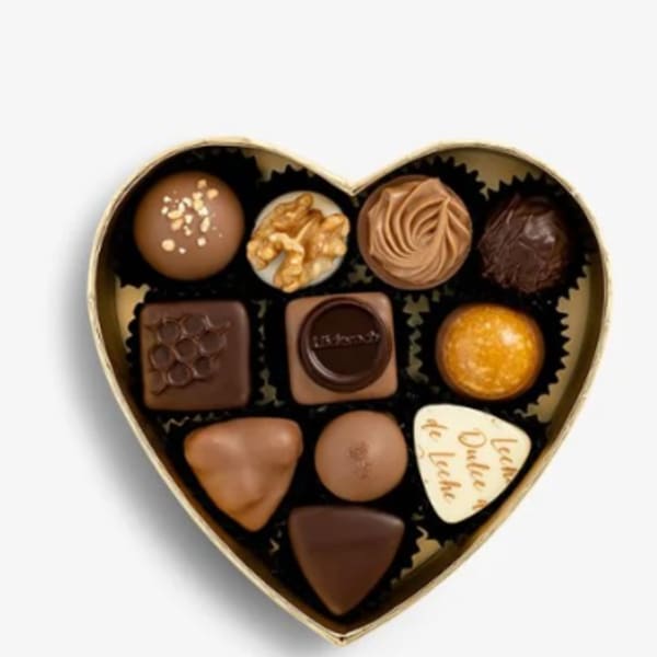 Heart-shaped box of assorted chocolates on a white background