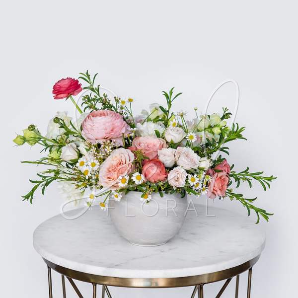 Pink and white mixed flower arrangement in a white vase
