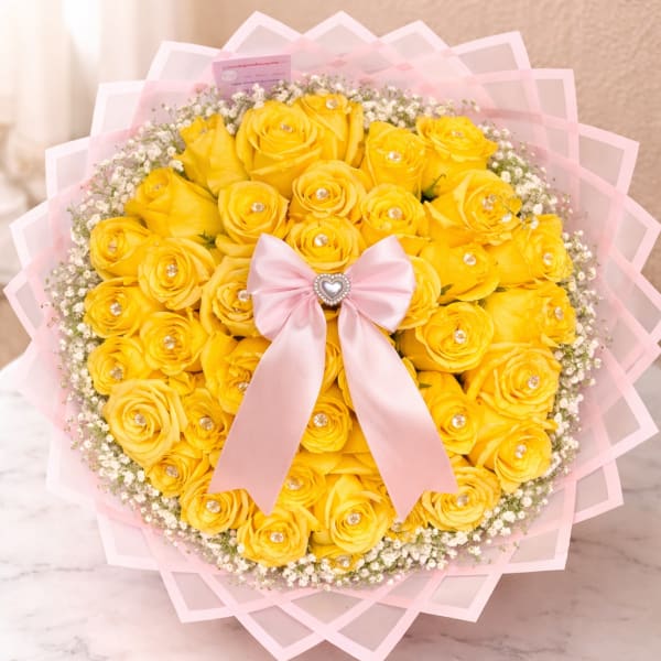 Bouquet of yellow roses with a pink ribbon and baby’s breath